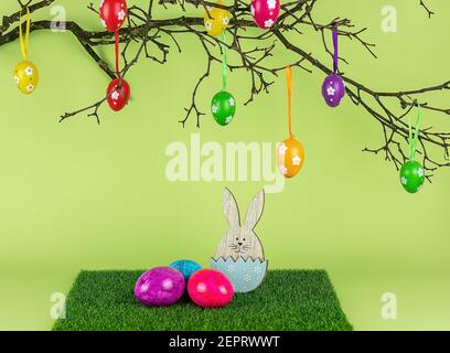 Easter tree, wooden bunny, and colored eggs. Holiday composition. Stock Photo