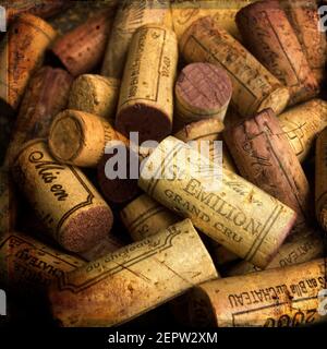 A collection of vintage french wine corks showcasing different brands and years, emphasizing craftsmanship and aged character in a cozy setting Stock Photo