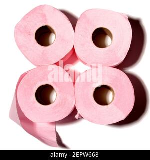 Four rolls of pink toilet paper arranged in a square on a contrasting background with soft shadow effects Stock Photo