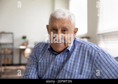 Head shot portrait smiling mature man looking at camera Stock Photo