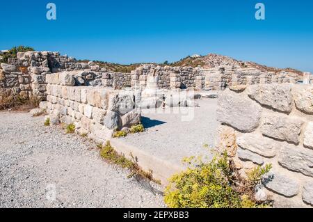 Ancient ruins on Agios Stefanos in Kefalos with view to the islet of Kastri iwith small chapel of Saint Nicholas , Kos Island, Greece (focus on the ru Stock Photo