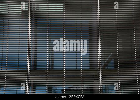 Symmetrically background of gray metal sunshades of a modern office building Stock Photo