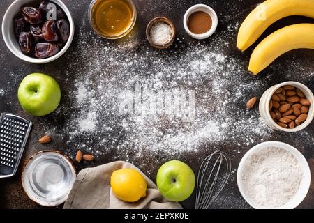 Frame of food ingredients for vegan baking on dark background Stock Photo