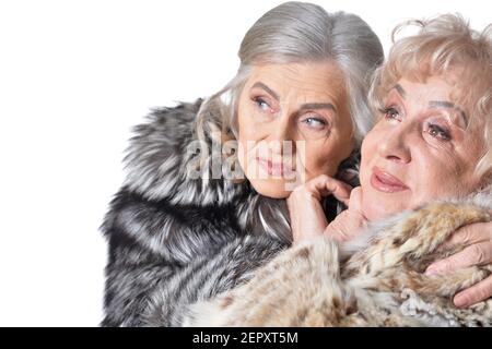 Close-up portrait of beautiful senior women in fur coats Stock Photo
