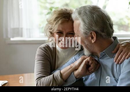 Happy older family couple laughing and hugging, expressing love Stock Photo