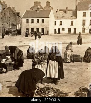 Irish fish-wives bargaining in the market-square, Galway, Ireland, 1903 Stock Photo