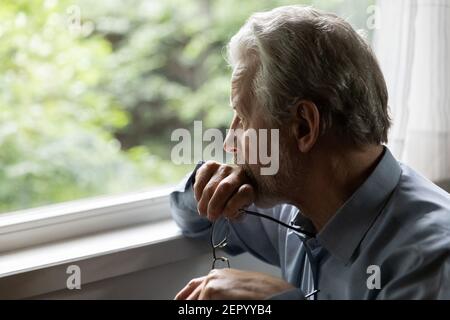 Pensive mature 70s aged man in deep thoughts Stock Photo