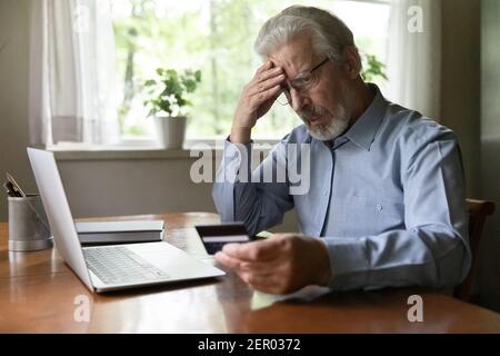 Upset senior man worried about finance safety Stock Photo