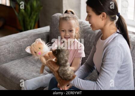 Happy mom and excited daughter girl wearing princess tiara Stock Photo