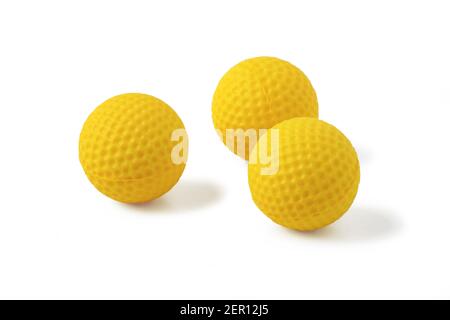 Yellow rubber balls for shooting childrens toy pistol isolated on white background Stock Photo