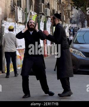 Jerusalem, Israel. 28th Feb, 2021. Drunk Ultra-Orthodox Jews celebrate Purim in Mea Shearim in Jerusalem, on Sunday, March 28, 2021. Photo by Debbie Hill/UPI Credit: UPI/Alamy Live News Stock Photo