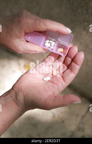 old woman hands holding a pills Stock Photo