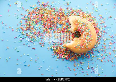 half eaten colorful donuts on blue background top down  Stock Photo