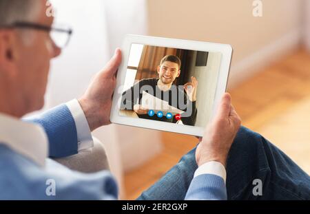 Man making video call with son using smartphone Stock Photo