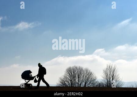 Kozakov, Czech Republic. 28th Feb, 2021. A man walking with baby in stroller on bright sunny day in the Bohemian Paradise (100 kilometers north from Prague) during the COVID-19 pandemic in the Czech Republic. Credit: Slavek Ruta/ZUMA Wire/Alamy Live News Stock Photo