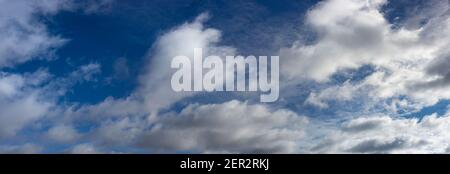 Blurred white clouds over blue sky and sunny day. Panorama of winter sky Stock Photo