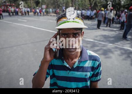 A congress party member wearing congress signed (Hand) cap during the mega rally staged by CPIM (Communist Party of India Marxist) at the brigade parade ground. Stock Photo