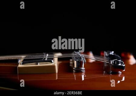 high contrast close up view for electric guitar. side view. music still life concept. bottom border Stock Photo