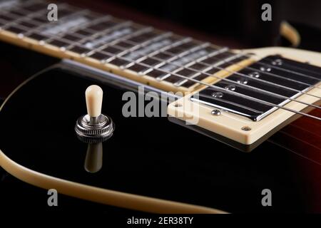close up view for electric guitar. dark moody studio shot. love music concept backdrop Stock Photo