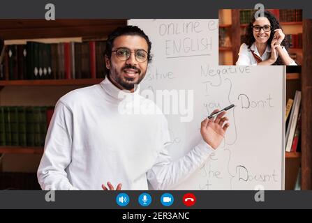 Indian man teacher explaining English grammar smiling woman, pov screen Stock Photo