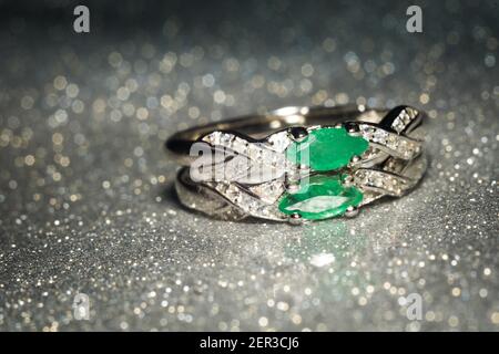 Fashion silver ring decorated with natural emerald stone. Stock Photo