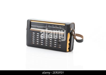 Old radio in a black leather case isolated on a white background. Stock Photo