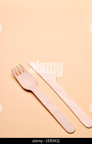 eco-friendly disposable utensills concept. bamboo or wooden cutlery over color background Stock Photo