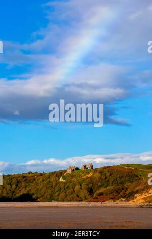 Rainbow over Pennard Castle at Three Cliffs Bay on the south coast of the Gower Peninsula near Swansea in South Wales UK Stock Photo