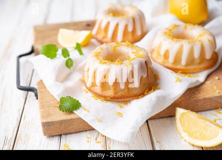 Tangy mini lemon bundt cakes topped with lemon glaze Stock Photo