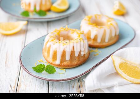 Tangy mini lemon bundt cakes topped with lemon glaze Stock Photo
