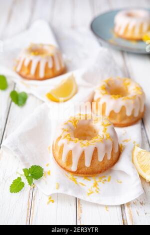 Tangy mini lemon bundt cakes topped with lemon glaze Stock Photo