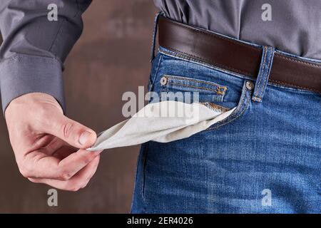 caucasian male person with empty jeans pocket. copy space. poverty and loser concept Stock Photo