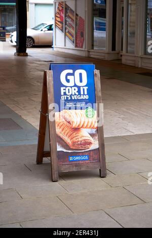 An A frame notice board advertising Greggs vegan sausage rolls Stock Photo