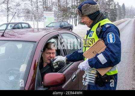 Finnish Police officers breathalysing drivers at random on a main road in north Finland Stock Photo