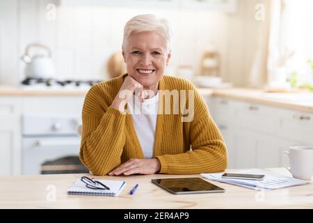 Happy senior woman freelancer working from home Stock Photo