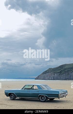 Classic American car on beach in Pendine Sands Wales UK Stock Photo