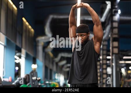 Muscular african american man bodybuilder doing workout at gym Stock Photo