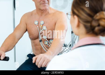 Doctor discussing with patient results of stress ECG Stock Photo