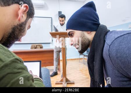 Arabic students discussing things in class Stock Photo