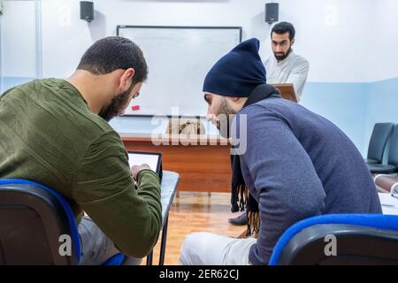 Arabic students discussing things in class Stock Photo