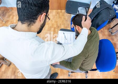 Arabic students discussing things in class Stock Photo