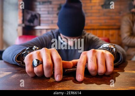 Arabic muslim man  putting his on restaurant table and feeling bored Stock Photo