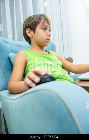 Arabic boy playing on laptop Stock Photo