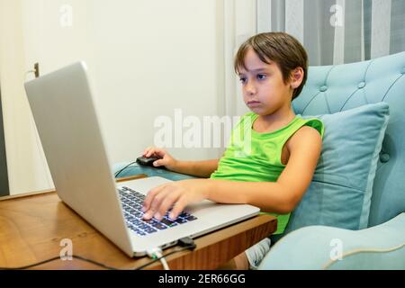 Arabic boy playing on laptop Stock Photo