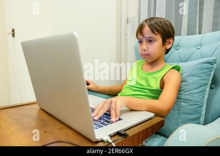 Arabic boy playing on laptop Stock Photo