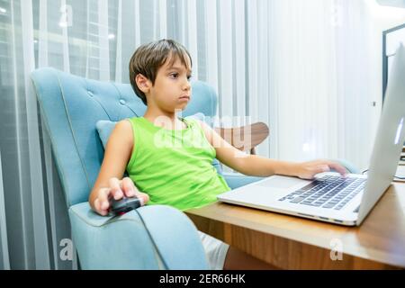 Arabic boy playing on laptop Stock Photo