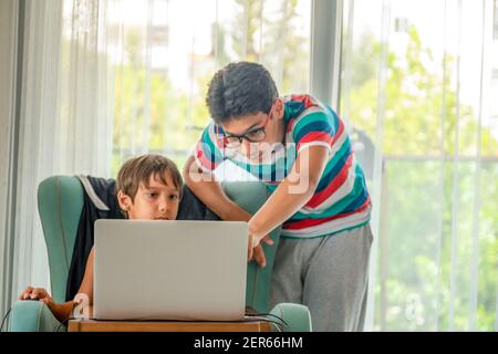 Arabic boy playing on laptop Stock Photo