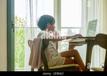 Arabic boy playing on laptop Stock Photo