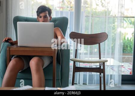 Arabic boy playing on laptop Stock Photo