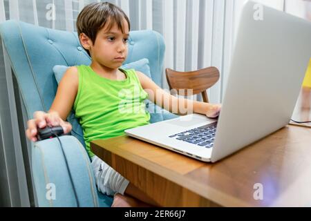 Arabic boy playing on laptop Stock Photo